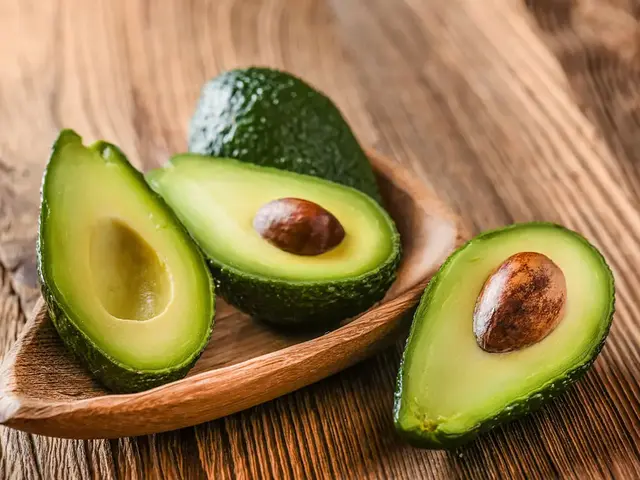 Halved avocados on a wooden board
