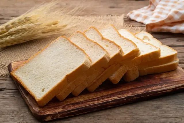 Slices of soft white bread on a board