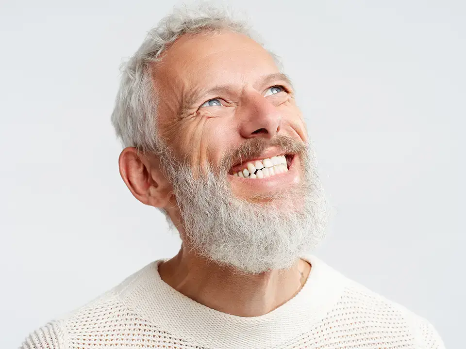 Smiling older man with a gray beard