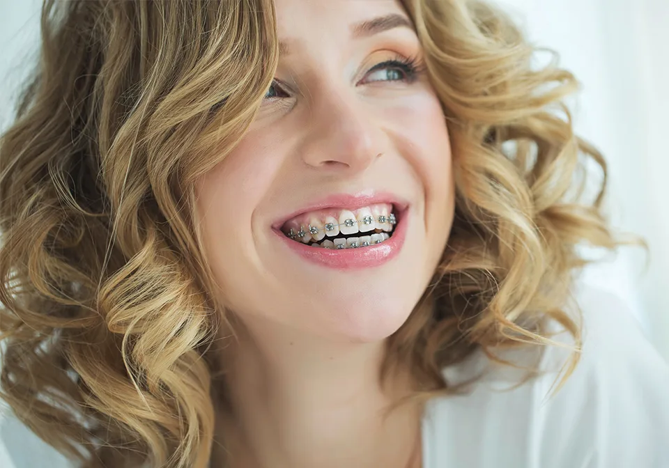 Smiling adult with braces