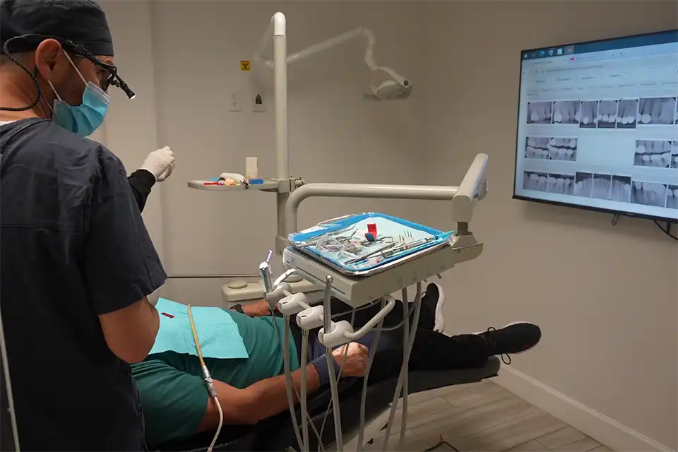 Dr. Tamir placing a dental implant for a patient full mouth dental implants cost