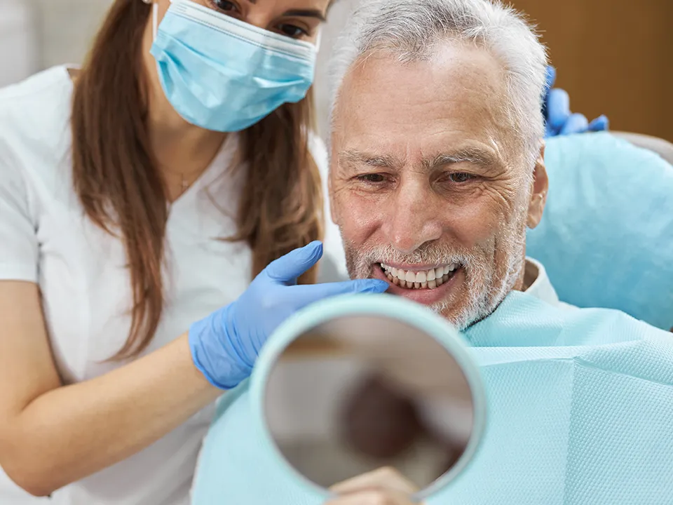 Elder Man Enjoying Newfound Smile Thanks to Dental Implants